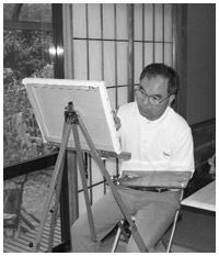 写真:キャンバスに向い絵筆を走らせる時間は至福の時